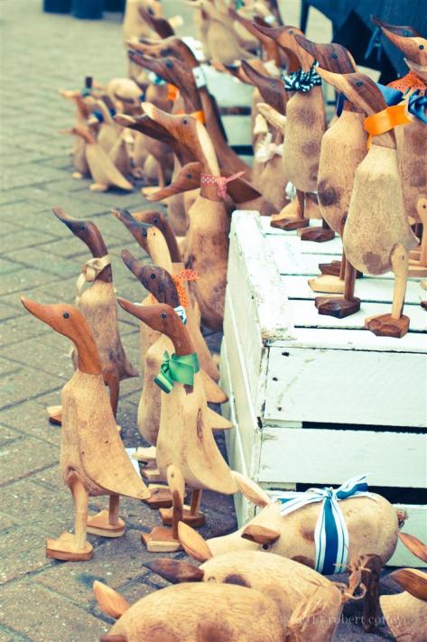 wooden duck ornaments on a market stall at the West Malling farmers market